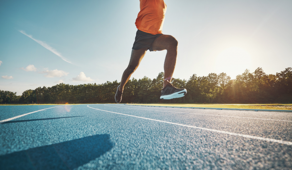 Athlete in mid air while sprinting down a running track