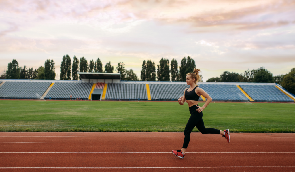 woman does slow runs in a track field