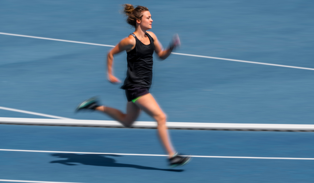 Female runner on tartan track