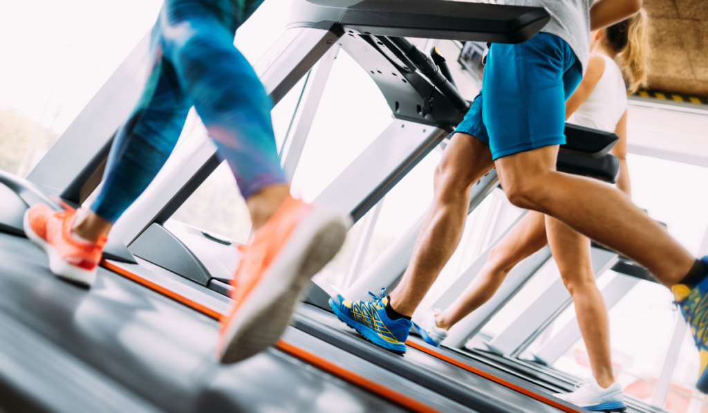 Group of friends exercising on treadmill machine
