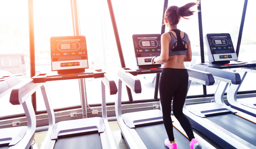 woman in ponytail Running on treadmill.