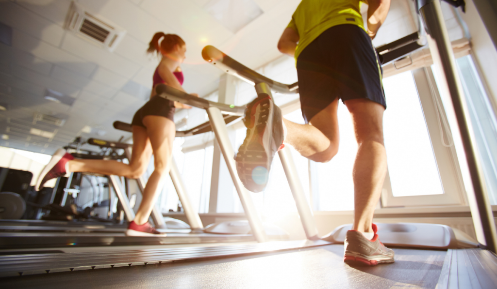 man and woman running on treadmills
