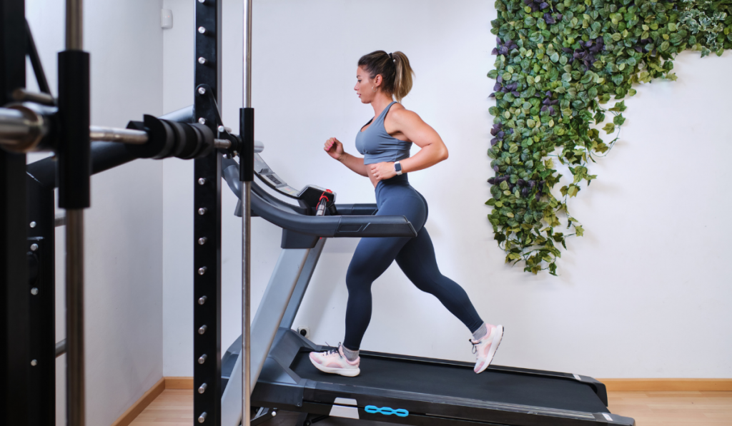 young woman running on a treadmill in a gym