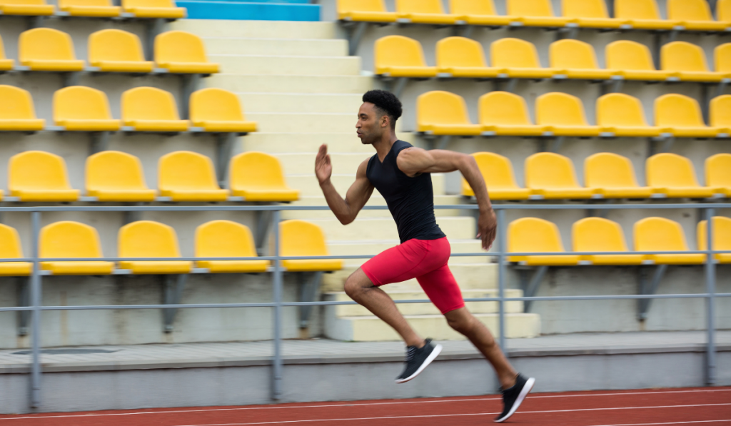 African athlete man run on running track outdoors