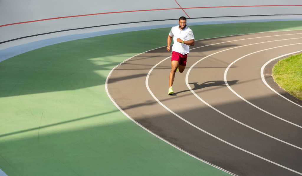 African American athlete running on the running track