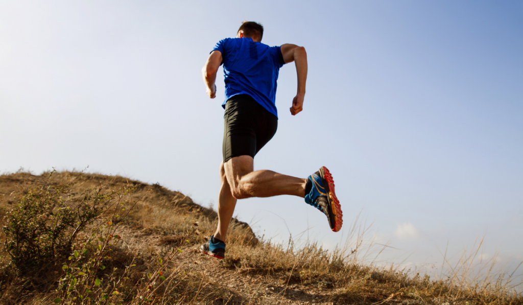 running autumn trail on male athlete runner