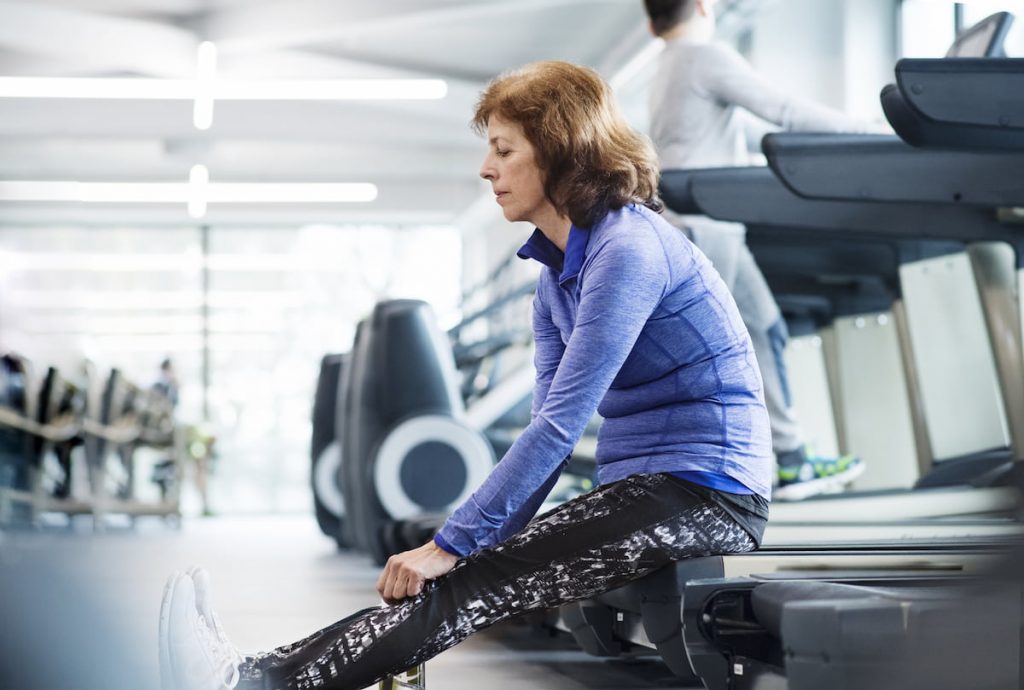 senior woman resting after treadmill work out