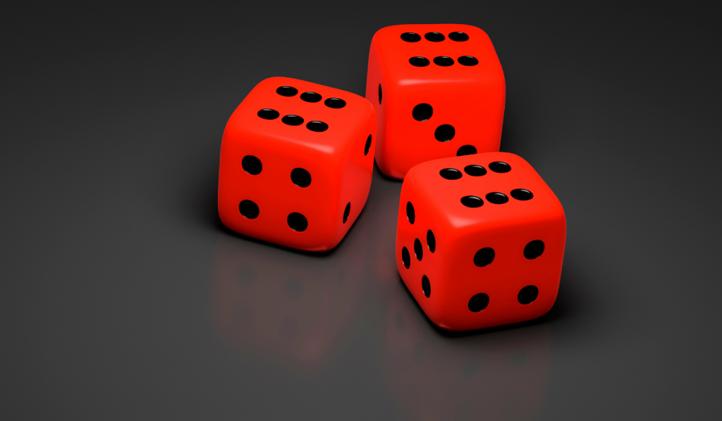 three red dice on a gray background
