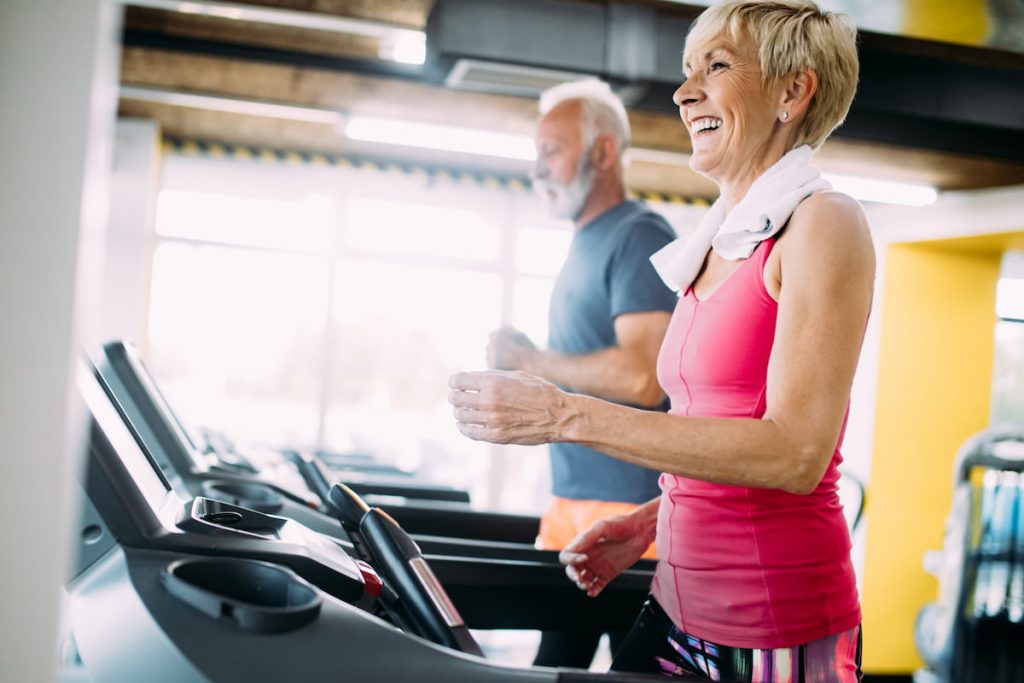 two seniors running on a treadmill 