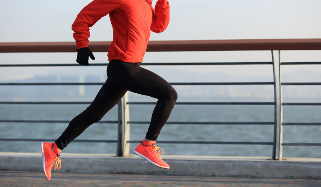 young fitness woman runner running at seaside
