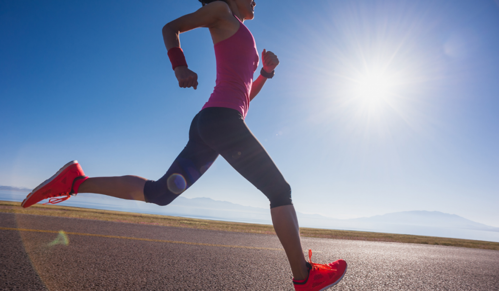 Healthy lifestyle young fitness woman runner running on sunrise road