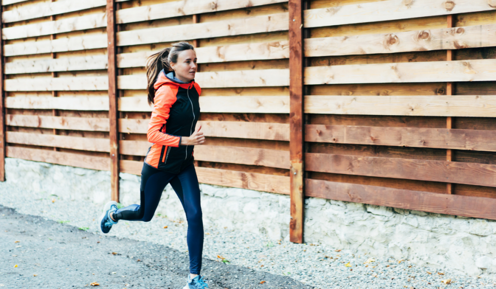 woman running with flat feet on the road