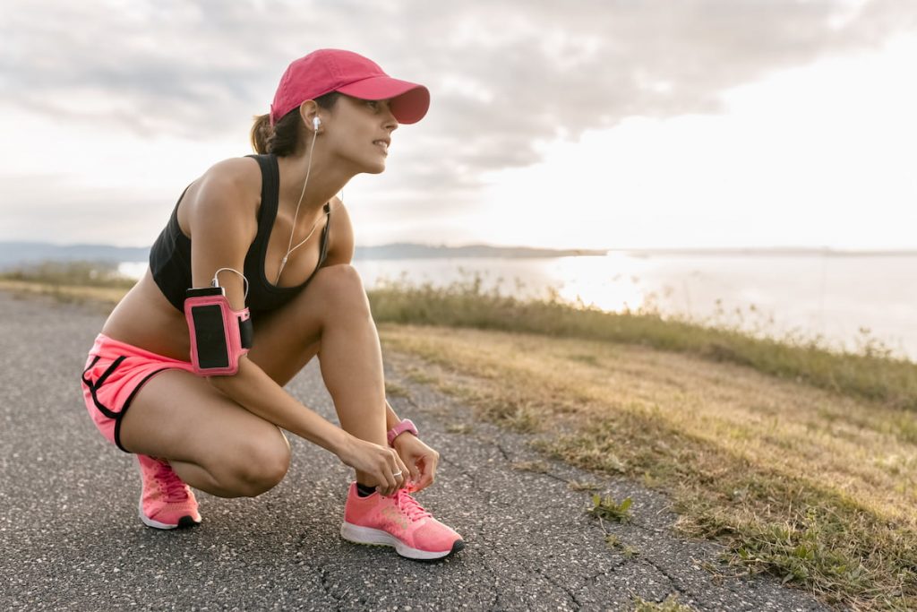 woman warming up for a run downhill 